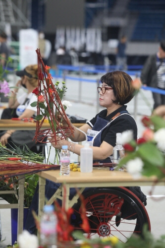 17일 강원도 강릉스피드스케이팅경기장에서 열린 제42회 전국장애인기능경기대회에서 화훼장식 직종에 참가한 선수들이 꽃 장식 위치를 고민하고 있다.ⓒ한국장애인고용공단